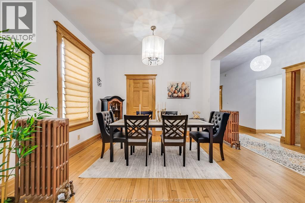 A dining room with a wooden table and chairs.