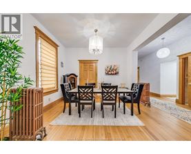 A dining room with a wooden table and chairs.