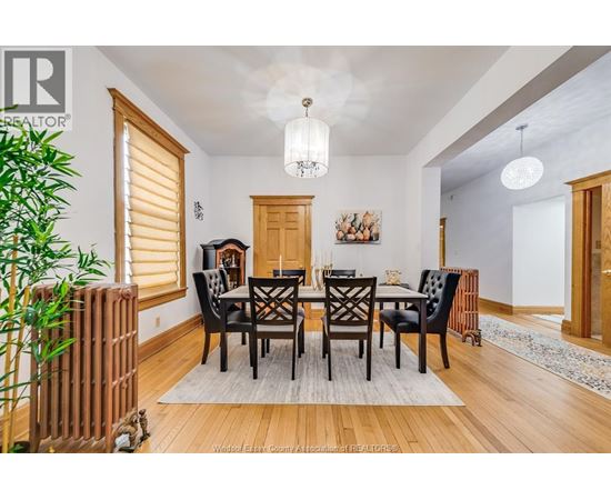 A dining room with a wooden table and chairs.