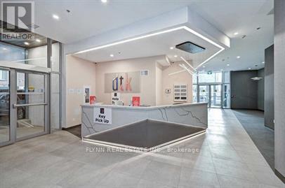 A reception area with a counter and a sign that says "Key Pick Up".
