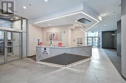A reception area with a counter and a sign that says "Key Pick Up".
