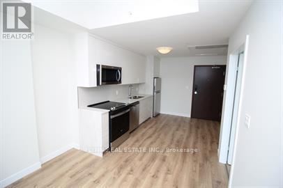 A kitchen area with a counter and a microwave.