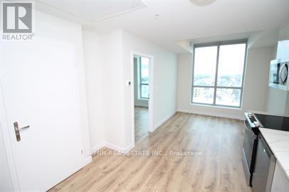 A spacious room with a door, a window, and a countertop.