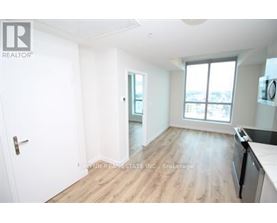 A spacious room with a door, a window, and a countertop.
