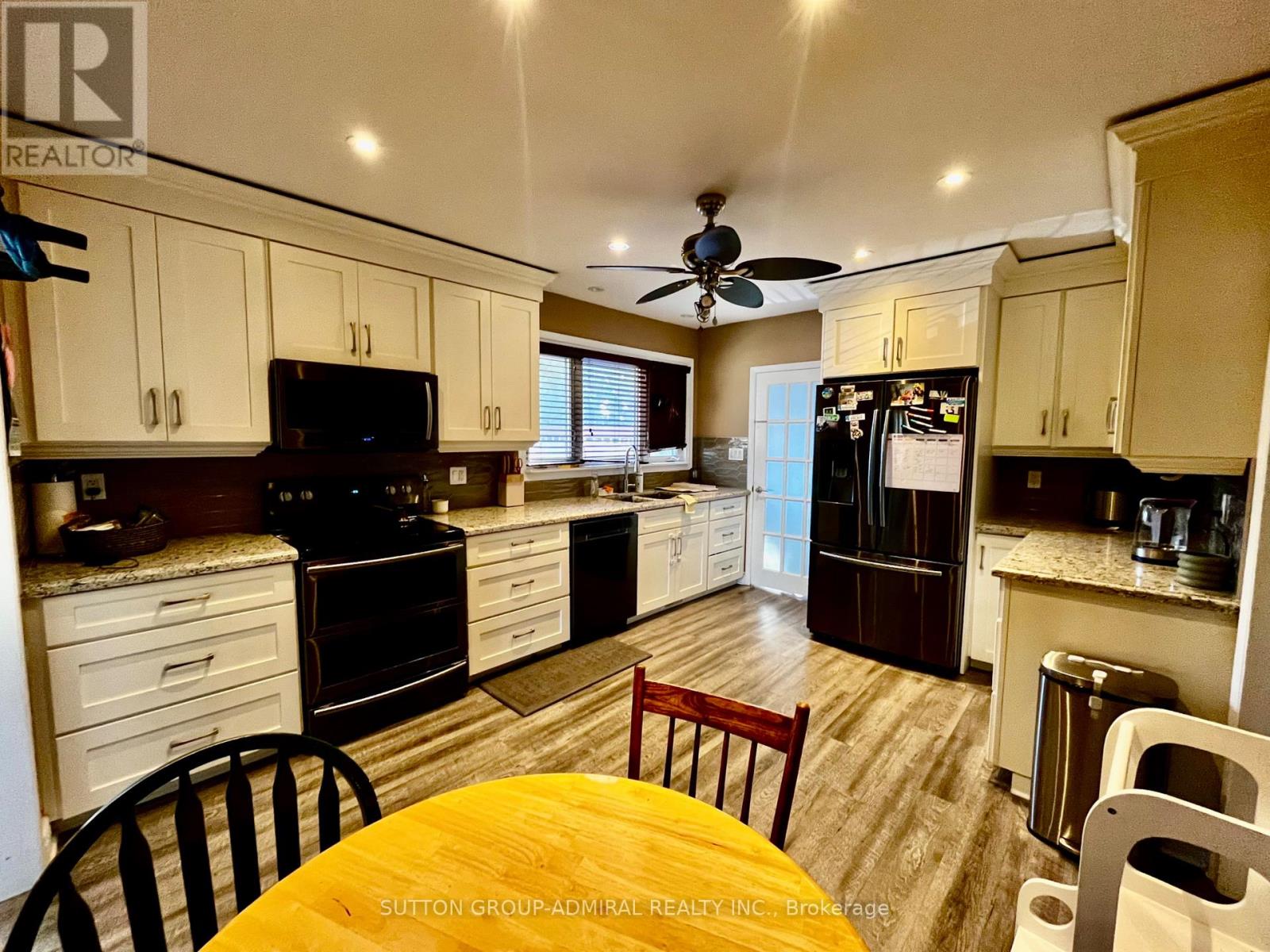 A kitchen with a table and chairs in the middle of it.