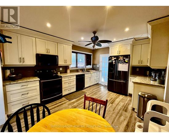 A kitchen with a table and chairs in the middle of it.