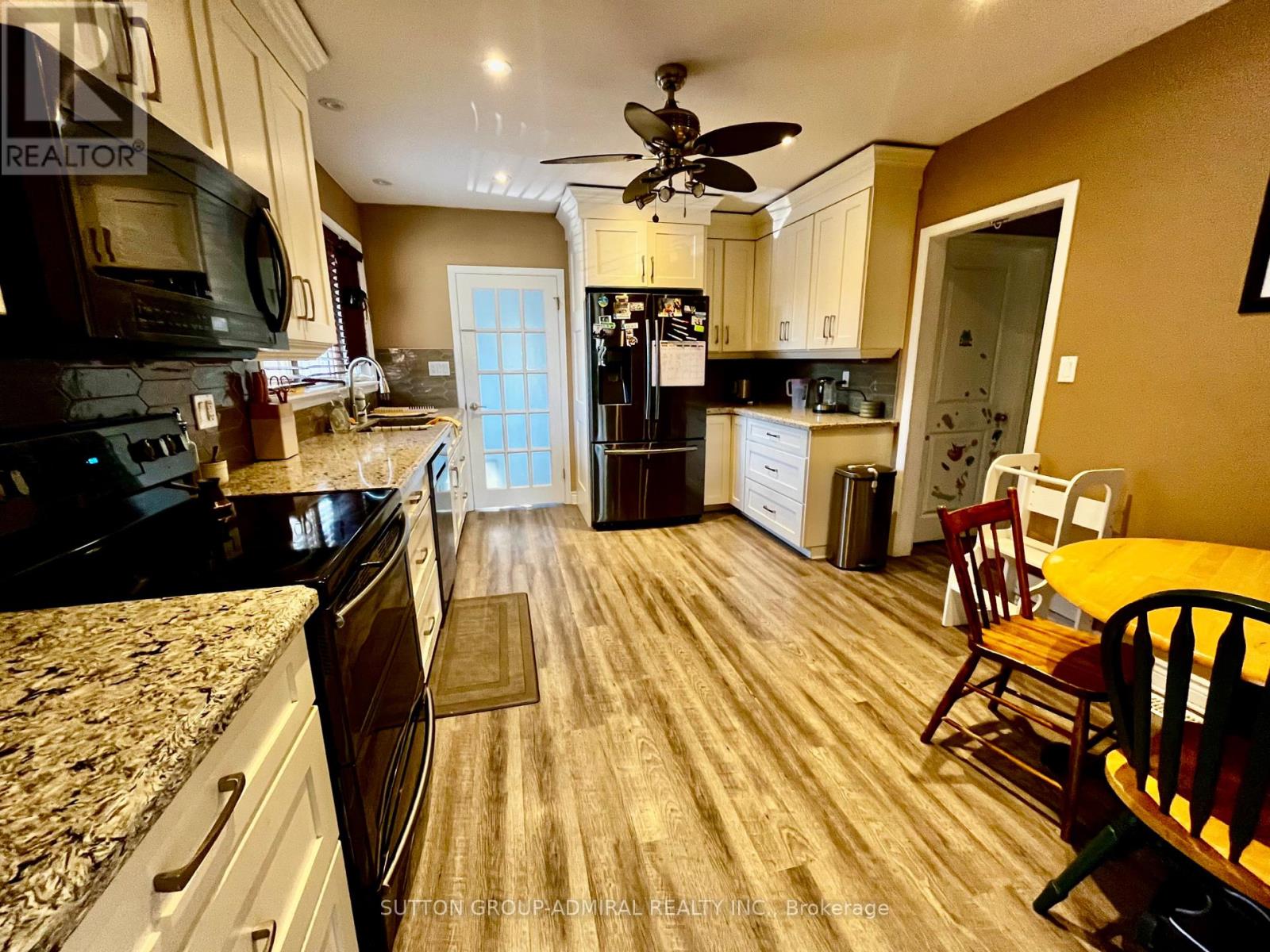 A kitchen with a table and chairs in the middle of the room.