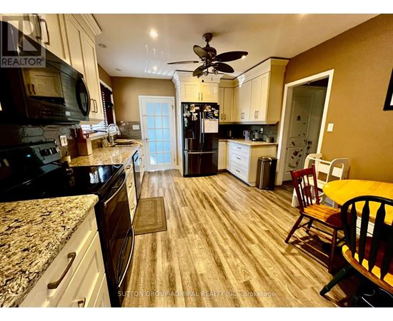 A kitchen with a table and chairs in the middle of the room.