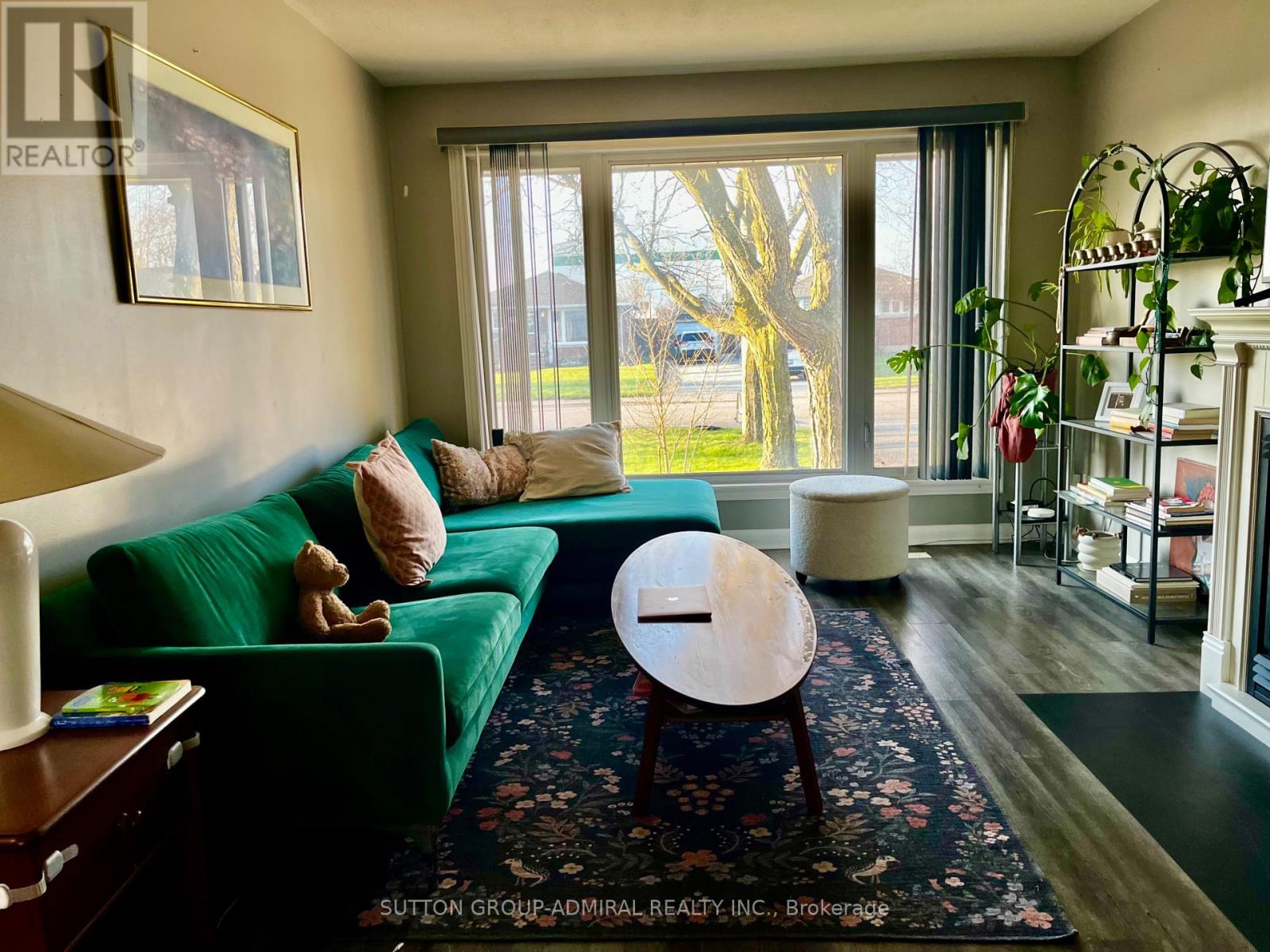 A living room with a green couch and a wooden coffee table.