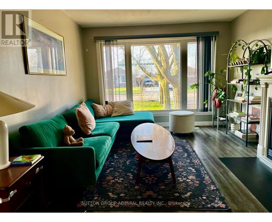 A living room with a green couch and a wooden coffee table.