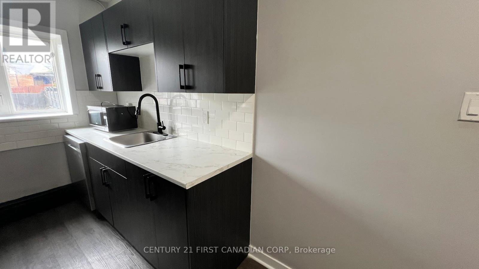 A kitchen with a sink and a window.