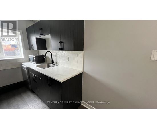 A kitchen with a sink and a window.