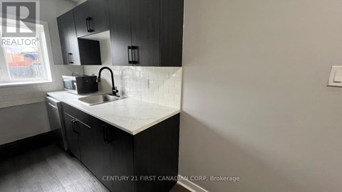 A kitchen with a sink and a window.