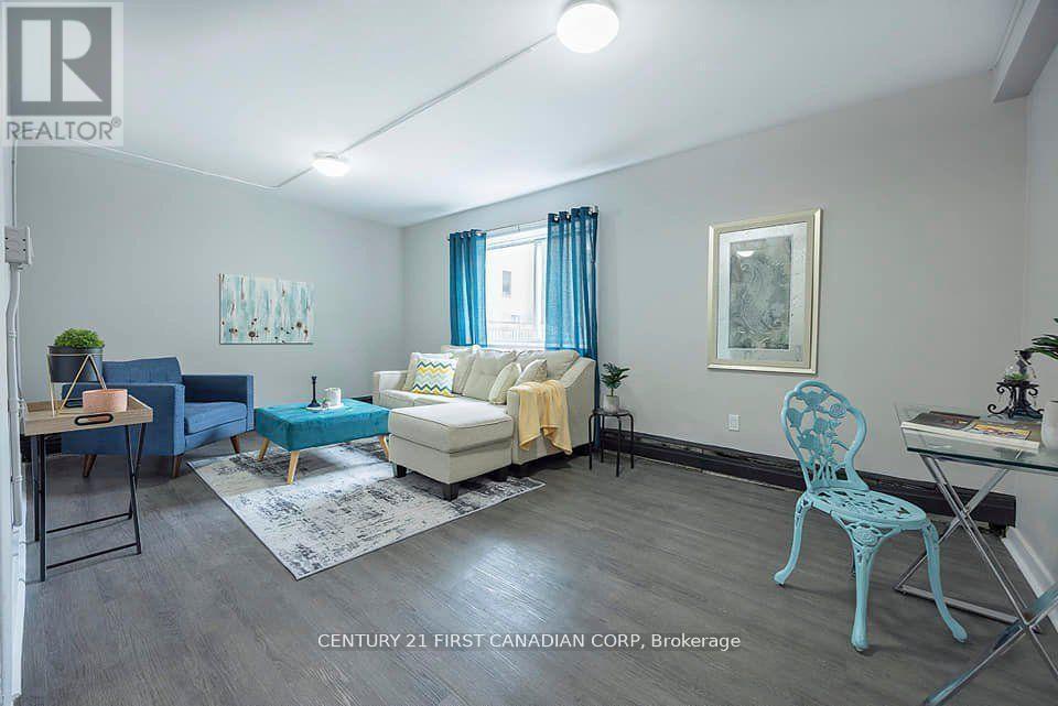 A living room with a blue chair and a white couch.