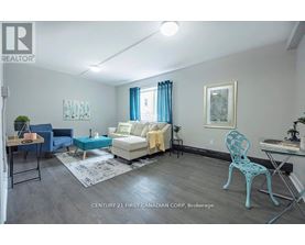 A living room with a blue chair and a white couch.