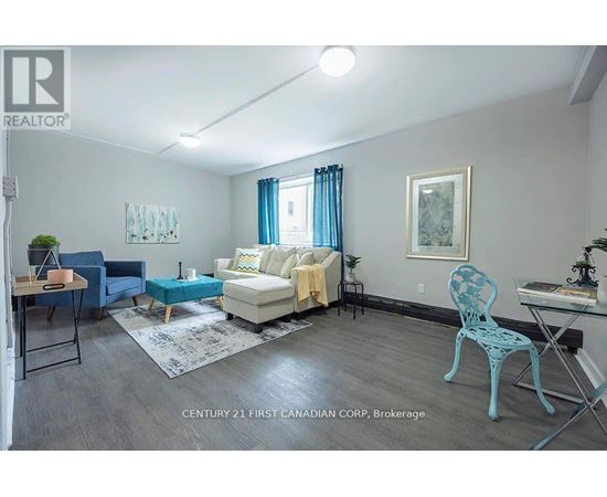 A living room with a blue chair and a white couch.