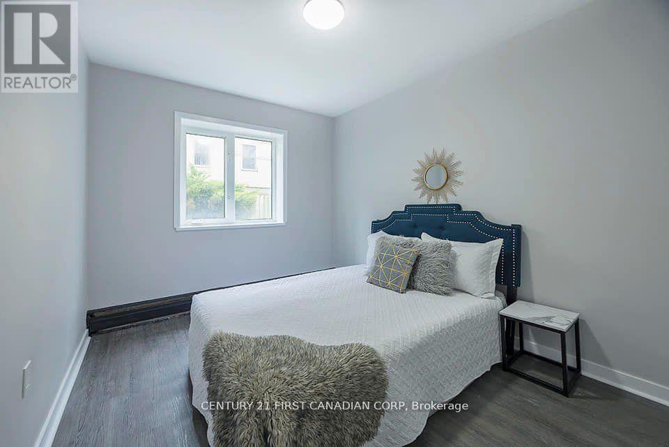 A bedroom with a bed, pillows, and a window.