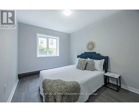 A bedroom with a bed, pillows, and a window.
