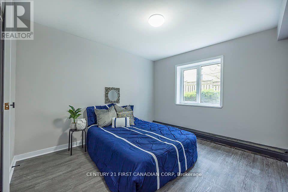 Bedroom with a bed, nightstand, and window.
