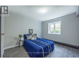 Bedroom with a bed, nightstand, and window.