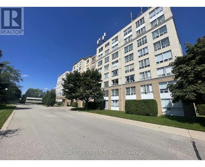 A street view of a residential building with a brokerage logo on the top left.