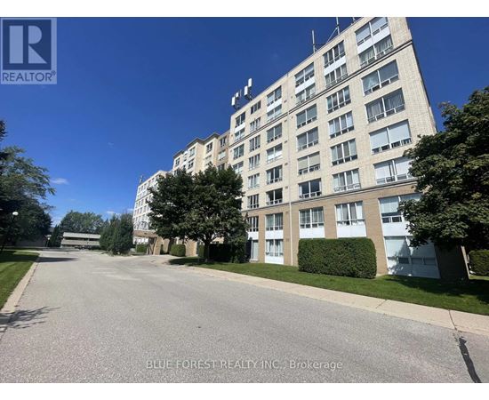 A street view of a residential building with a brokerage logo on the top left.