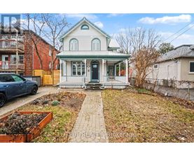 A house with a green roof and a white porch.