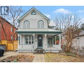 A house with a green roof and a porch with white railings.