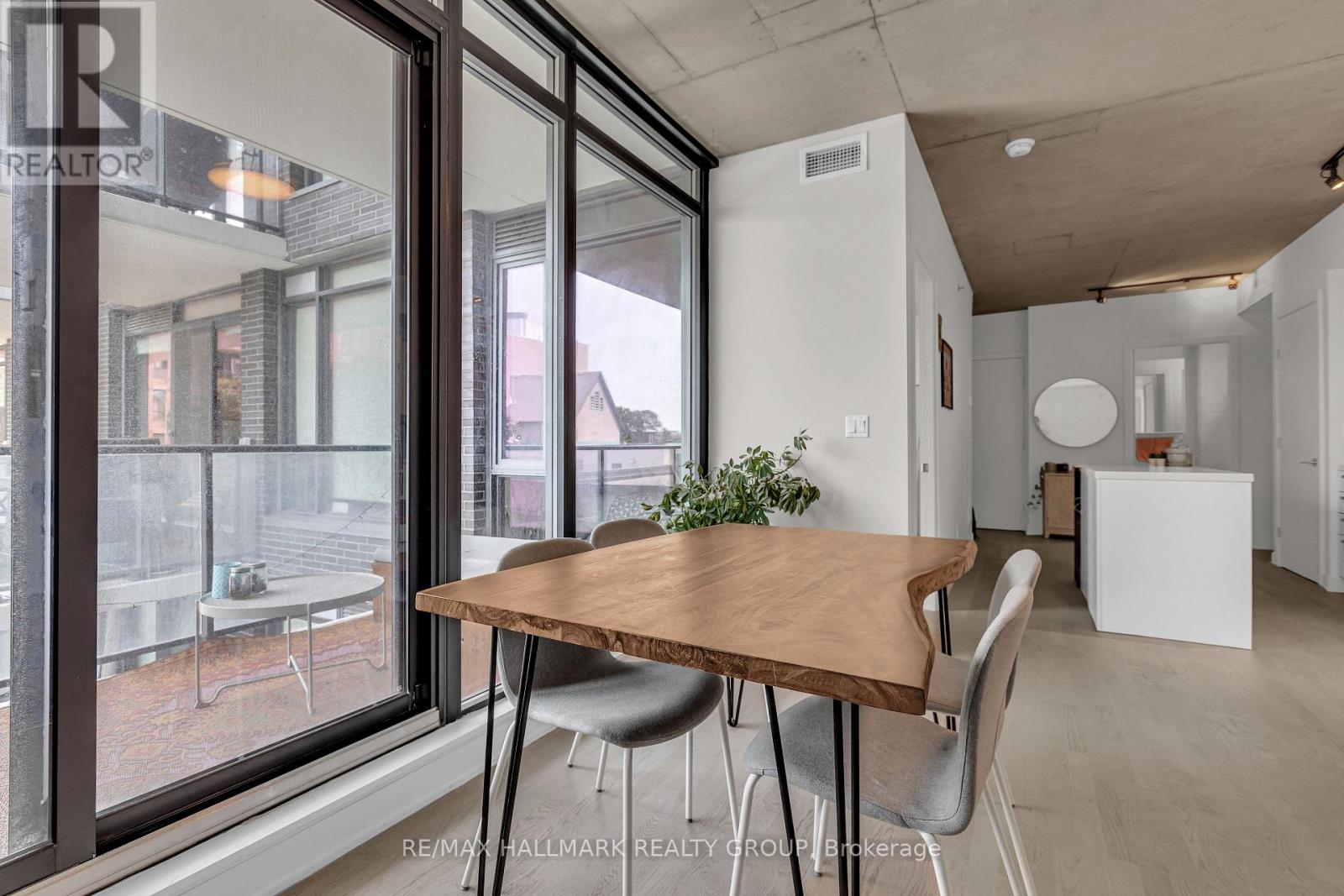 A dining area with a wooden table and grey chairs.