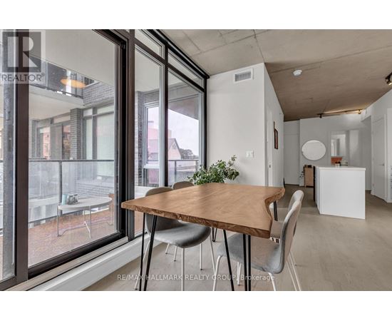 A dining area with a wooden table and grey chairs.