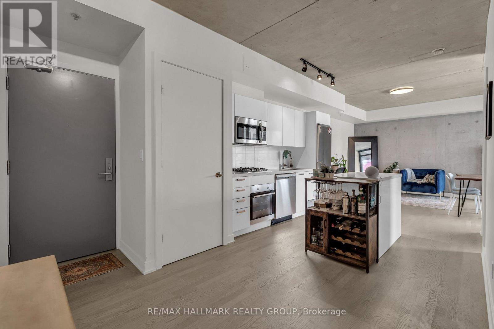 A modern kitchen with white cabinets and a wooden island.
