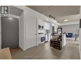 A modern kitchen with white cabinets and a wooden island.