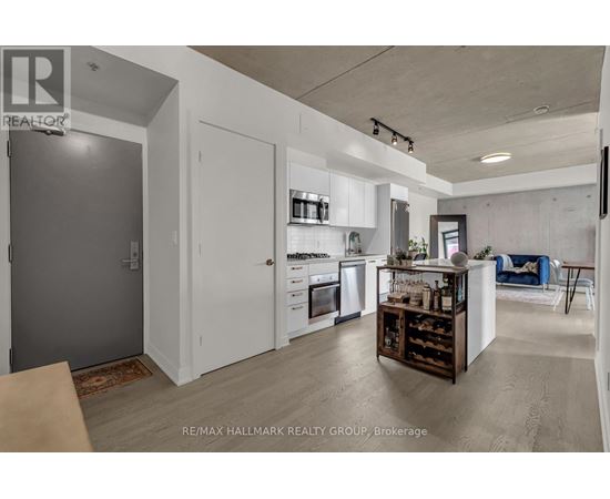 A modern kitchen with white cabinets and a wooden island.
