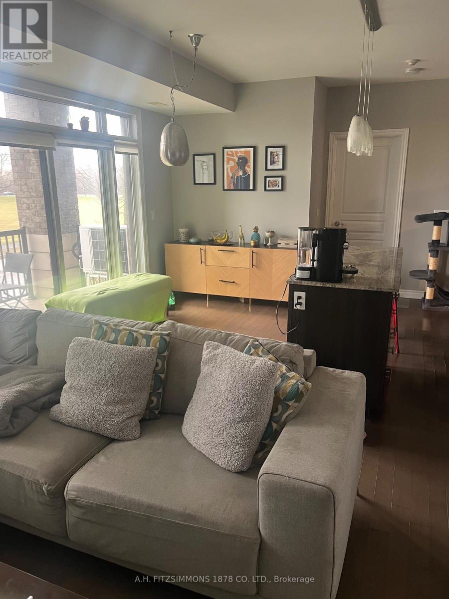 A living room with a grey couch and a wooden cabinet.