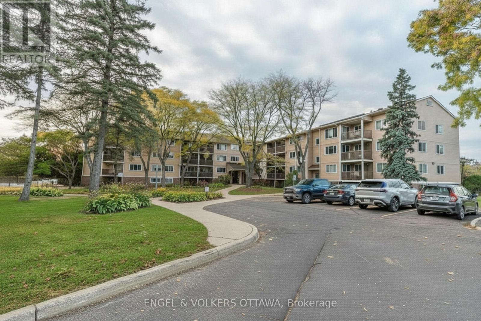 A brokerage office is located in a building with a parking lot in front.