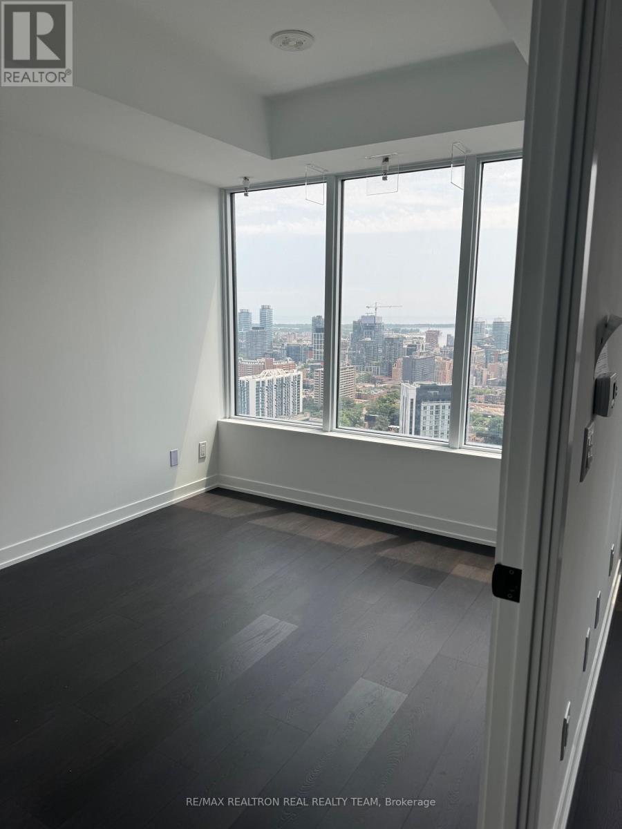 A room with a view of the cityscape through large windows.