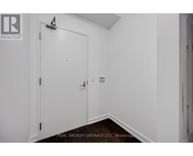 A white door with a Real Broker logo on it.