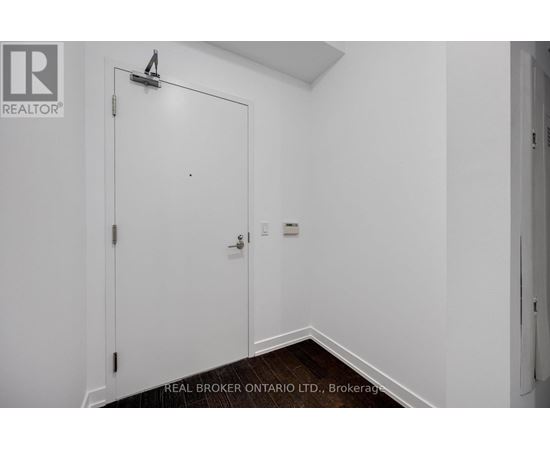 A white door with a Real Broker logo on it.