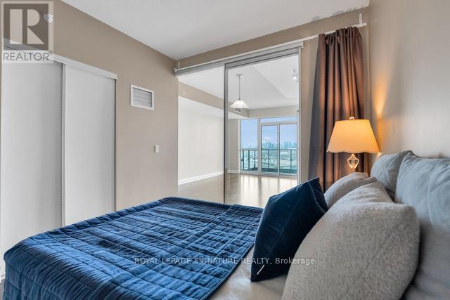 A bedroom with a large bed and a view of the city.