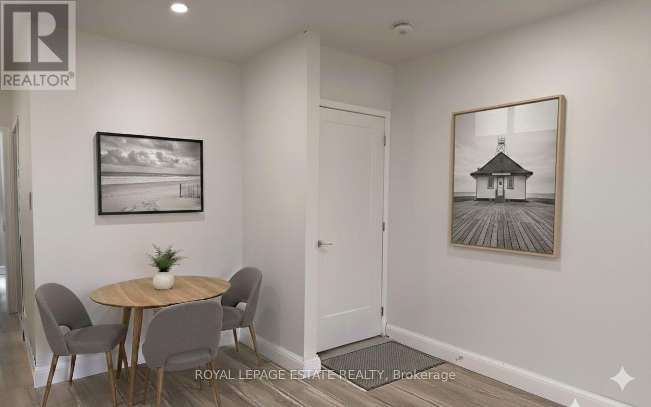 A dining room with a table and chairs.