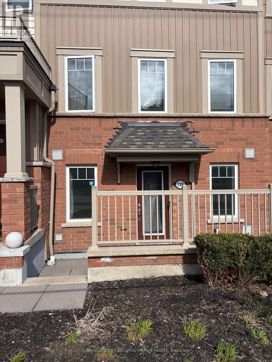 A brick house with a small front porch.