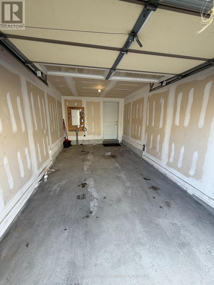 A spacious garage with a concrete floor and walls under construction.