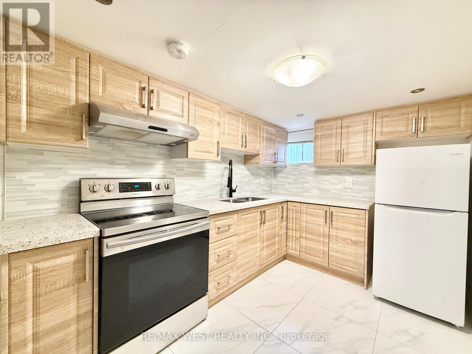 A kitchen with wooden cabinets and a white refrigerator.