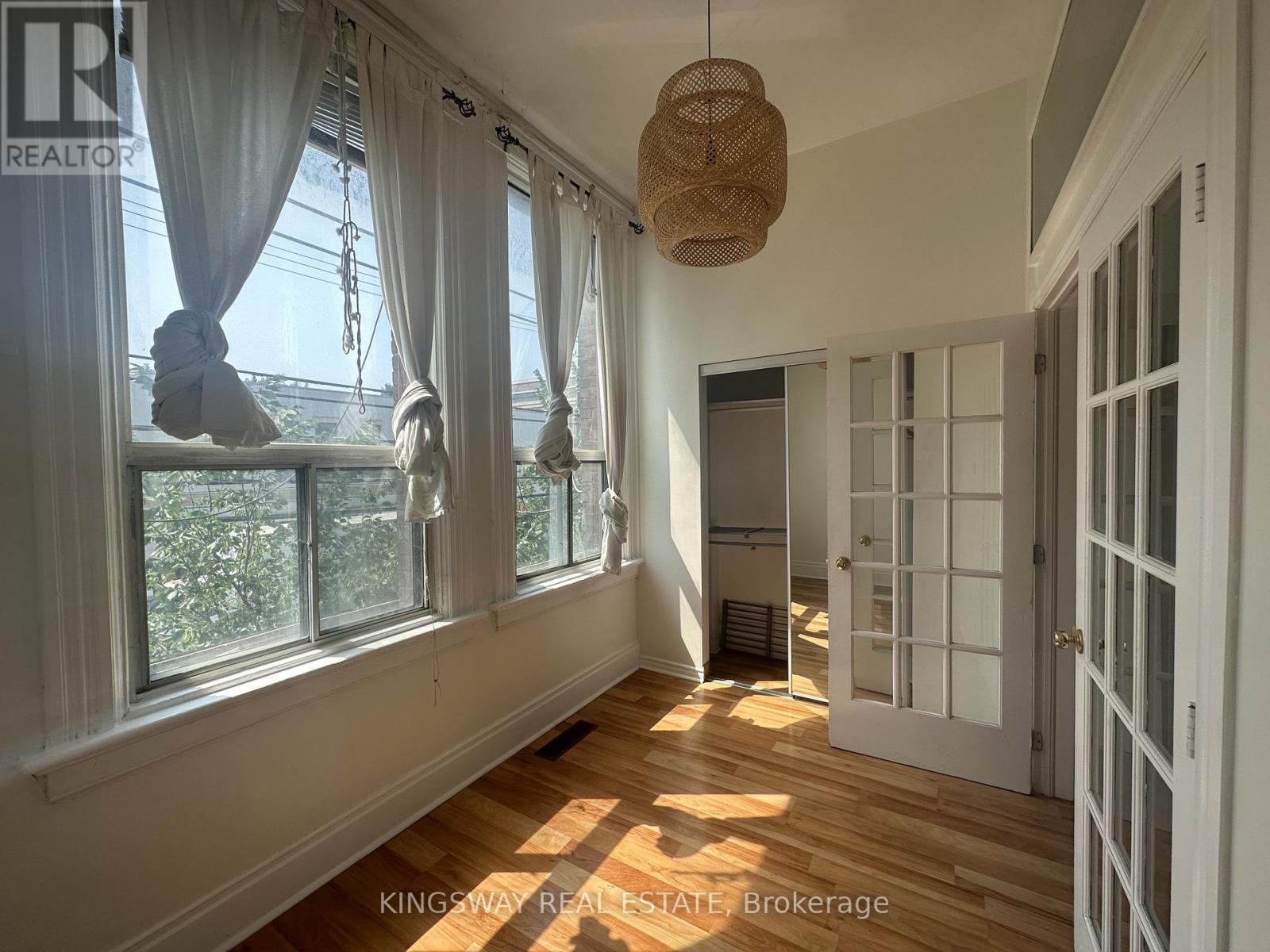 A sunny room with a window and a door.