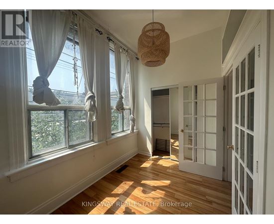 A sunny room with a window and a door.