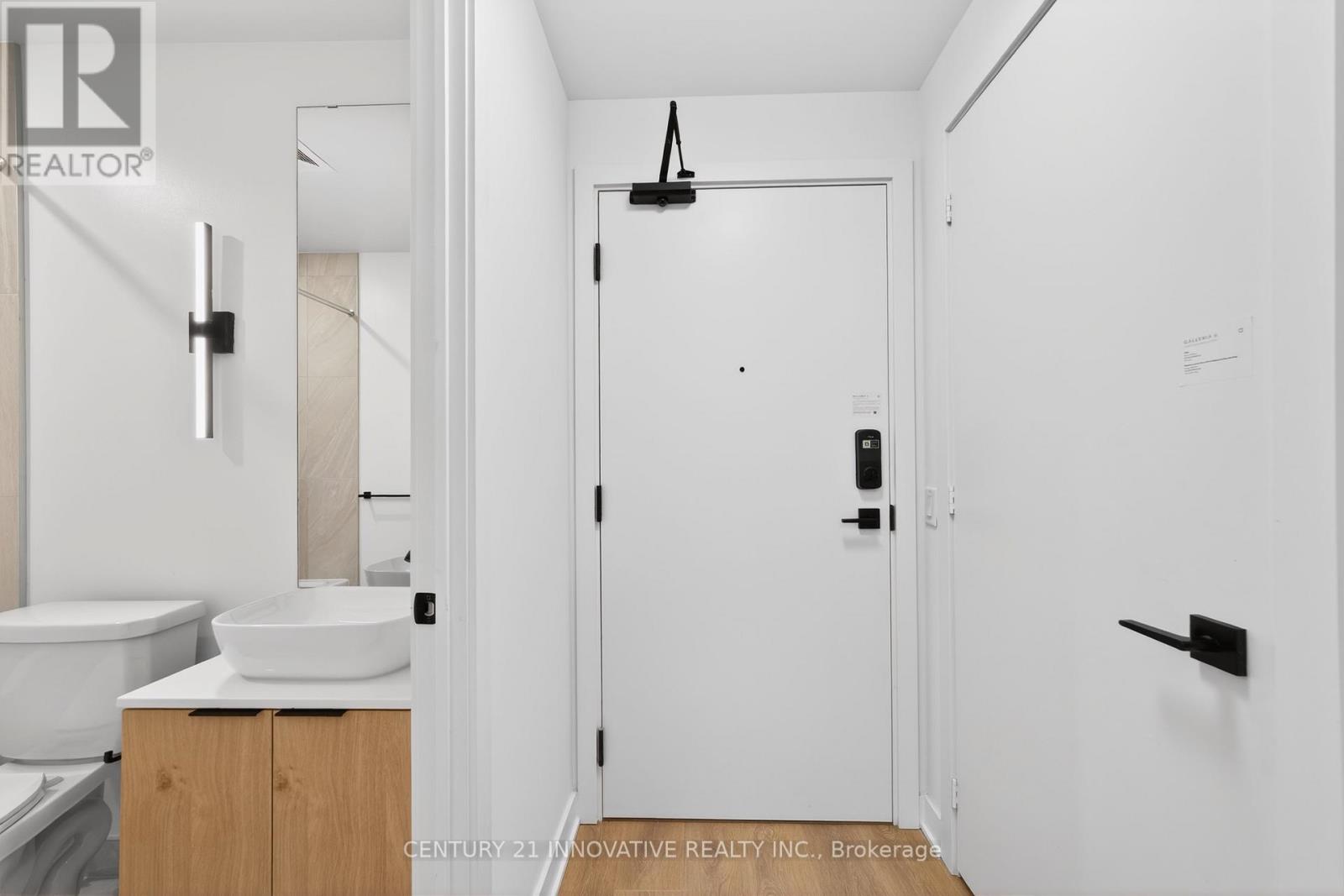 A white bathroom with a sink and toilet.