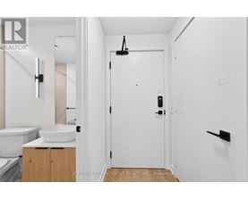 A white bathroom with a sink and toilet.