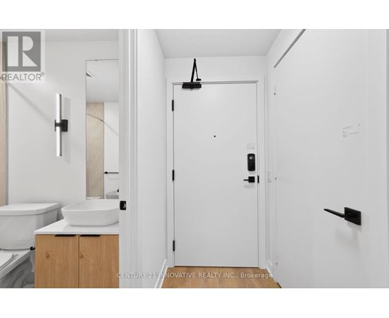 A white bathroom with a sink and toilet.