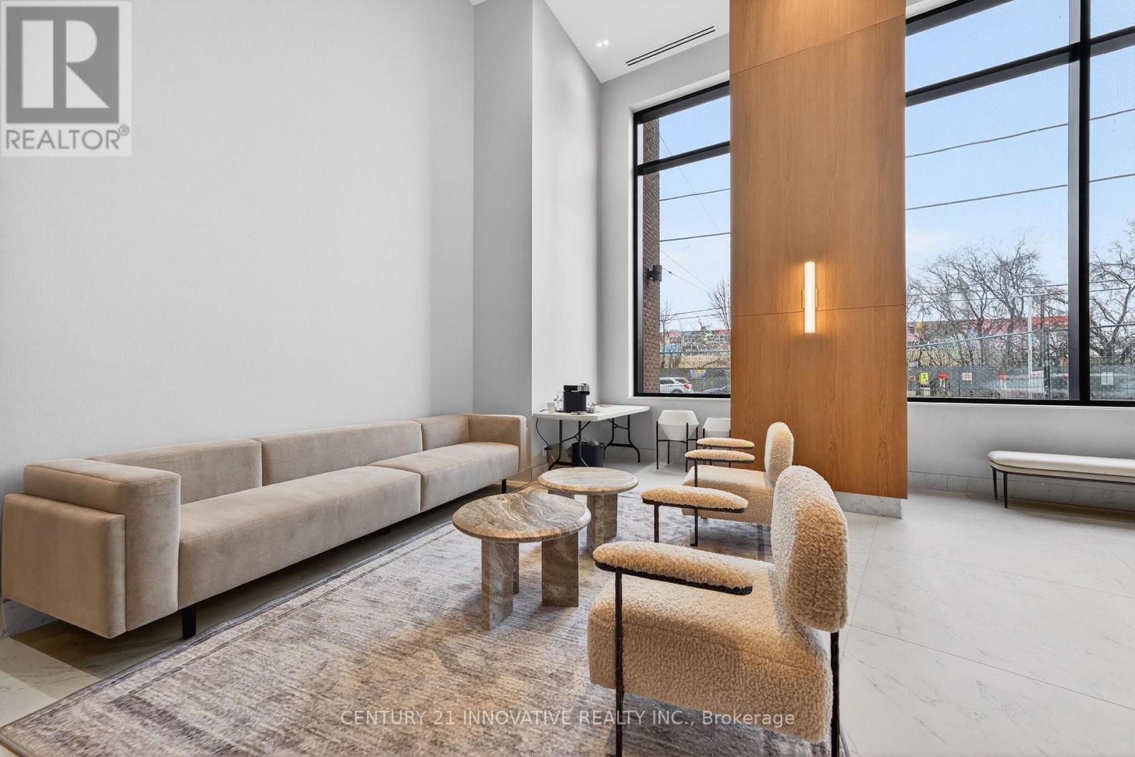 A modern living room with a large window and a long couch.