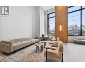 A modern living room with a large window and a long couch.